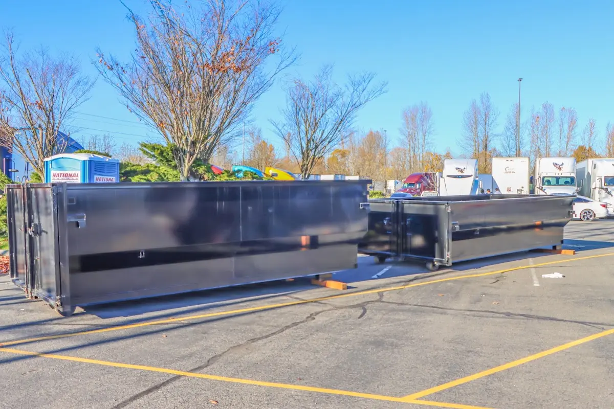 Professional dumpster rental service with roll-off container on residential driveway in Clarkdale